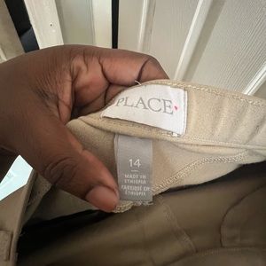 The children place girl’s uniform pants leggings